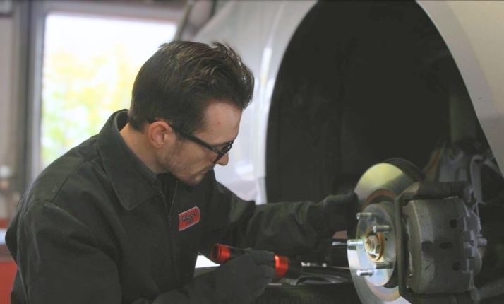 Commercial Tire employee inspecting brakes