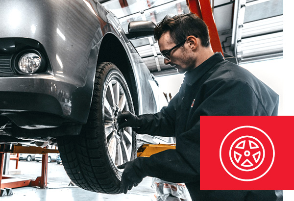 Photo of a Commercial Tire employee installing a tire